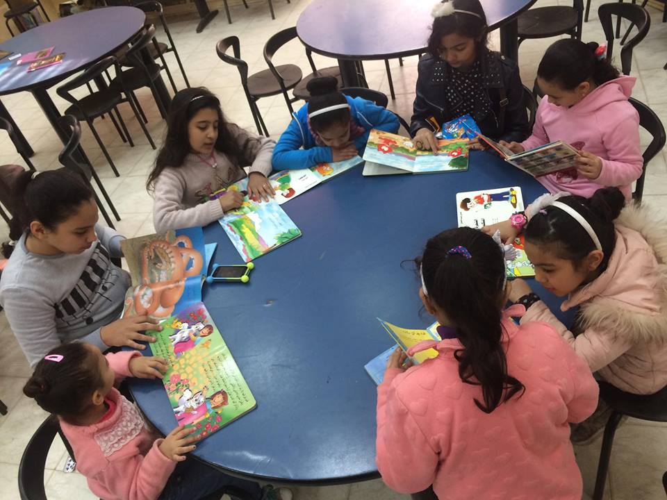 Practice library members reading stories, drawing and coloring